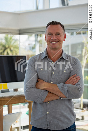 Portrait of confident businessman standing at studio Portrait of confident businessman standing at studio 34362119