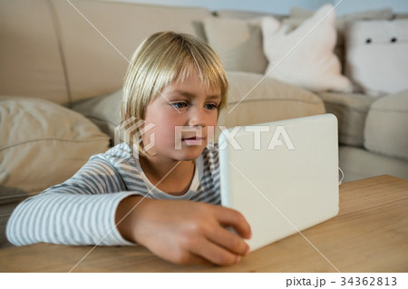 Boy using digital tablet in the living room 34362813