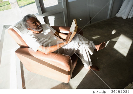 Senior man reading a book at home Senior man reading a book at home 34363085