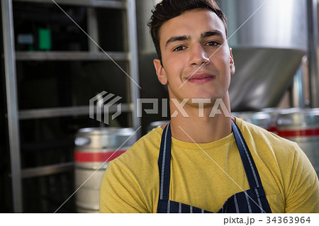 Portrait of confident worker by storage tank Portrait of confident worker by storage tank 34363964