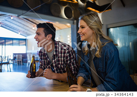Happy friends looking away at bar 34364143