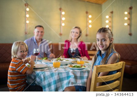 Portrait of happy family in restaurant 34364413