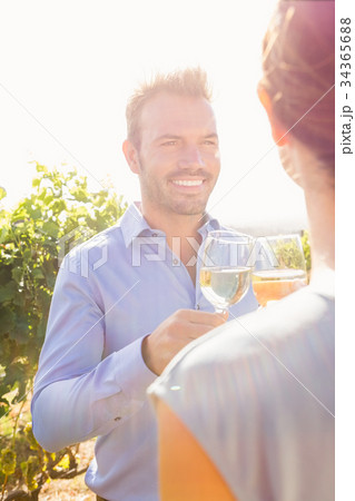 Smiling man with woman toasting wine 34365688