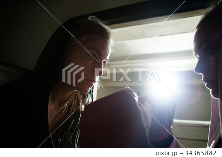 Trainer assisting woman in boxing 34365882