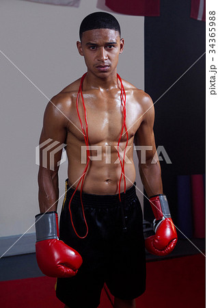 Confident man standing in fitness studio Confident man standing in fitness studio 34365988