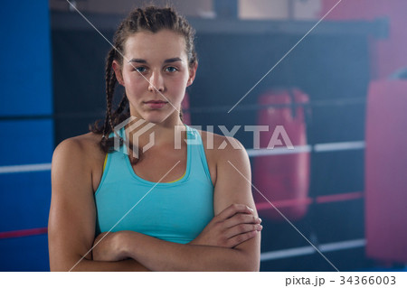 Portrait of confident young female athlete with arms crossed Portrait of confident young female athlete with arms crossed 34366003
