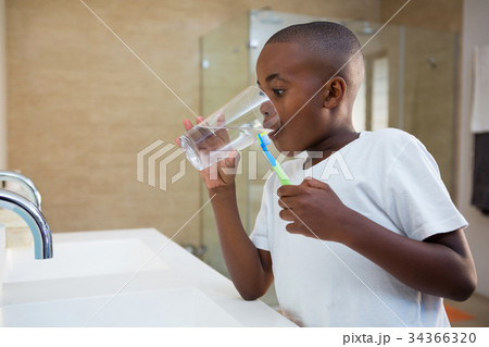 Boy drinking water from glass Boy drinking water from glass 34366320