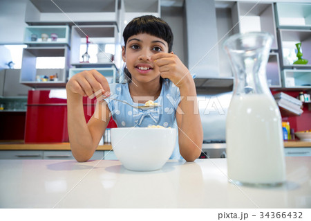 Portrait of girl eating healthy breakfast Portrait of girl eating healthy breakfast 34366432