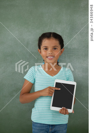 Young girl holding digital tablet Young girl holding digital tablet 34366948