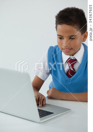 Schoolboy using laptop 34367605