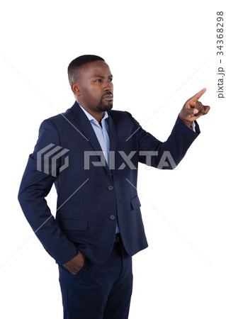 Businessman pressing an invisible virtual screen Businessman pressing an invisible virtual screen 34368298