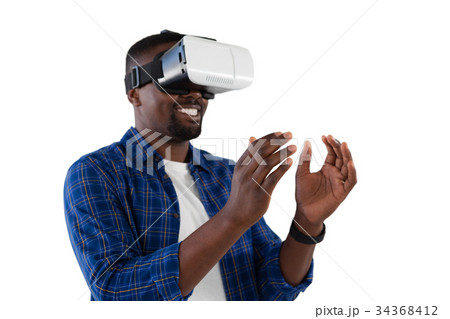 Man gesturing while using virtual reality headset Man gesturing while using virtual reality headset 34368412
