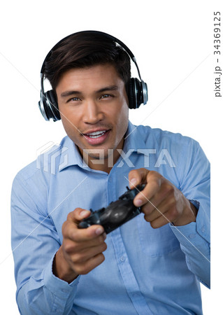 Portrait of smiling young businessman playing video game Portrait of smiling young businessman playing video game 34369125