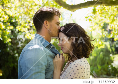 Man kissing woman on forehead Man kissing woman on forehead 34369932