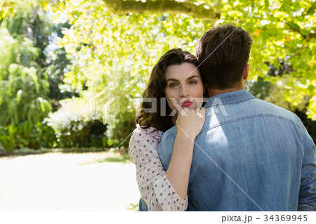 Couple embracing each other in garden 34369945