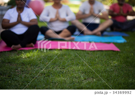 Senior people sitting on exercise mats 34369992
