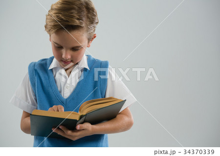 Schoolboy reading book 34370339