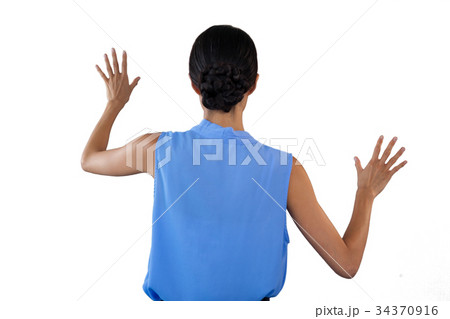 Businesswoman in sleeveless clothing touching interface Businesswoman in sleeveless clothing touching interface 34370916