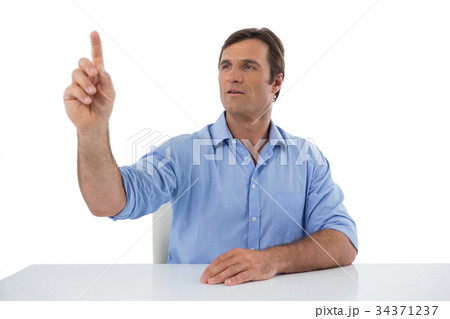 Male executive pressing an invisible virtual screen 34371237