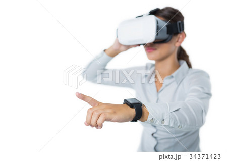 Female executive using virtual reality headset Female executive using virtual reality headset 34371423