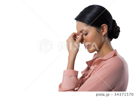 Tensed female executive against white background 34371570