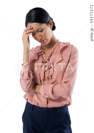 Tensed female executive standing against white background Tensed female executive standing against white background 34371571
