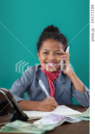 Smiling businesswoman talking on mobile phone 34371598