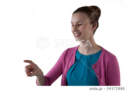 Teenage girl pressing an invisible virtual screen 34372980