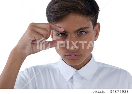 Boy gesturing against white background 34372983