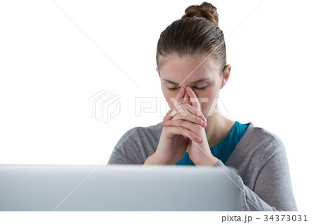 Teenage girl sitting against white background Teenage girl sitting against white background 34373031