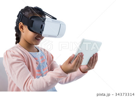 Girl using virtual reality headset and digital tablet Girl using virtual reality headset and digital tablet 34373314