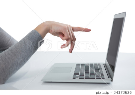 Teenage girl pointing at laptop screen 34373626