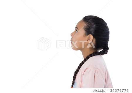 Thoughtful girl standing against white background Thoughtful girl standing against white background 34373772