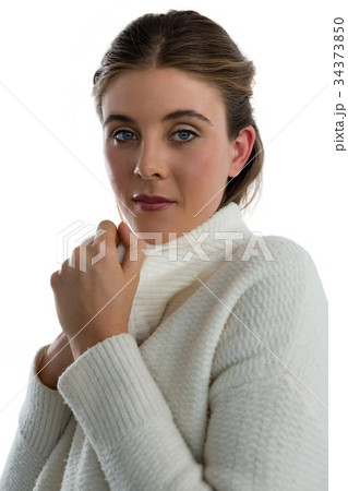 Portrait of young woman wearing sweater Portrait of young woman wearing sweater 34373850