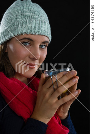 Portrait of woman holding coffee cup Portrait of woman holding coffee cup 34374269