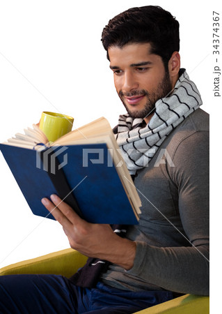 Man reading book while having coffee Man reading book while having coffee 34374367