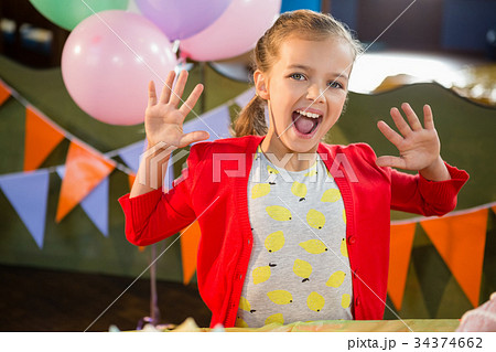 Portrait of excited girl in birthday party 34374662