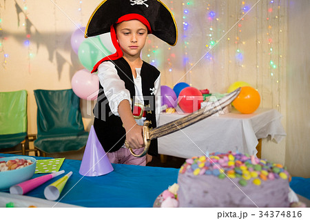 Boy pretending to be as pirate during birthday party 34374816