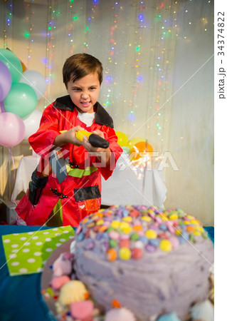 Cute boy pretending to be a fireman during birthday party 34374822