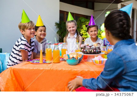 Friends talking during birthday party 34375067
