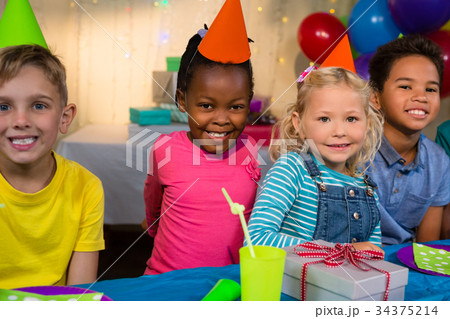Portrait of smiling children at birthday party Portrait of smiling children at birthday party 34375214