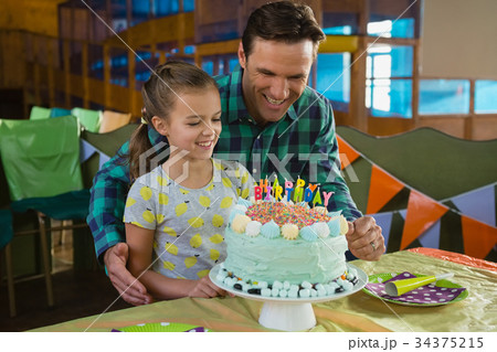 Father and daughter with birthday cake 34375215
