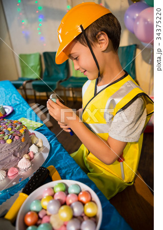 Boy pretending as a worker during birthday party Boy pretending as a worker during birthday party 34375220