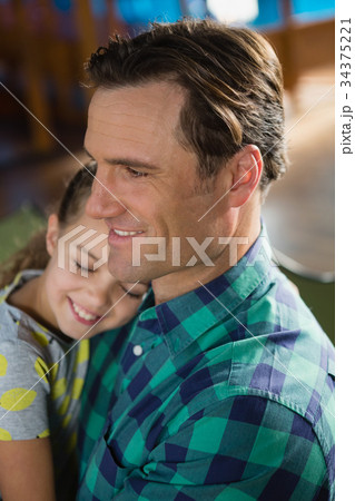 Close-up of cute daughter embracing father Close-up of cute daughter embracing father 34375221