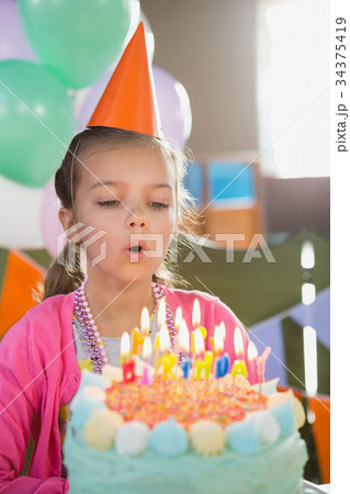Birthday girl blowing birthday candles 34375419