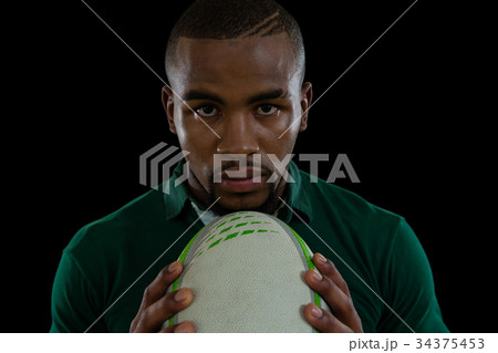 Close up portrait of confident male athlete with rugby ball 34375453