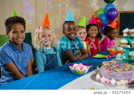 Portrait of smiling children sitting at table 34375455