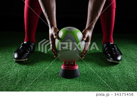 Low section sportsman keeping ball on tee 34375456