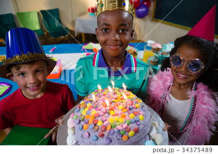 High angle portrait of boy holding birthday cake 34375489