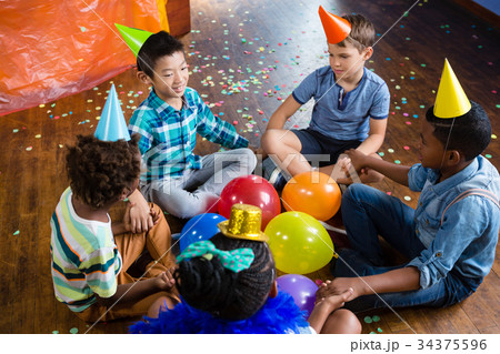 High angle view of children sitting with holding hands 34375596